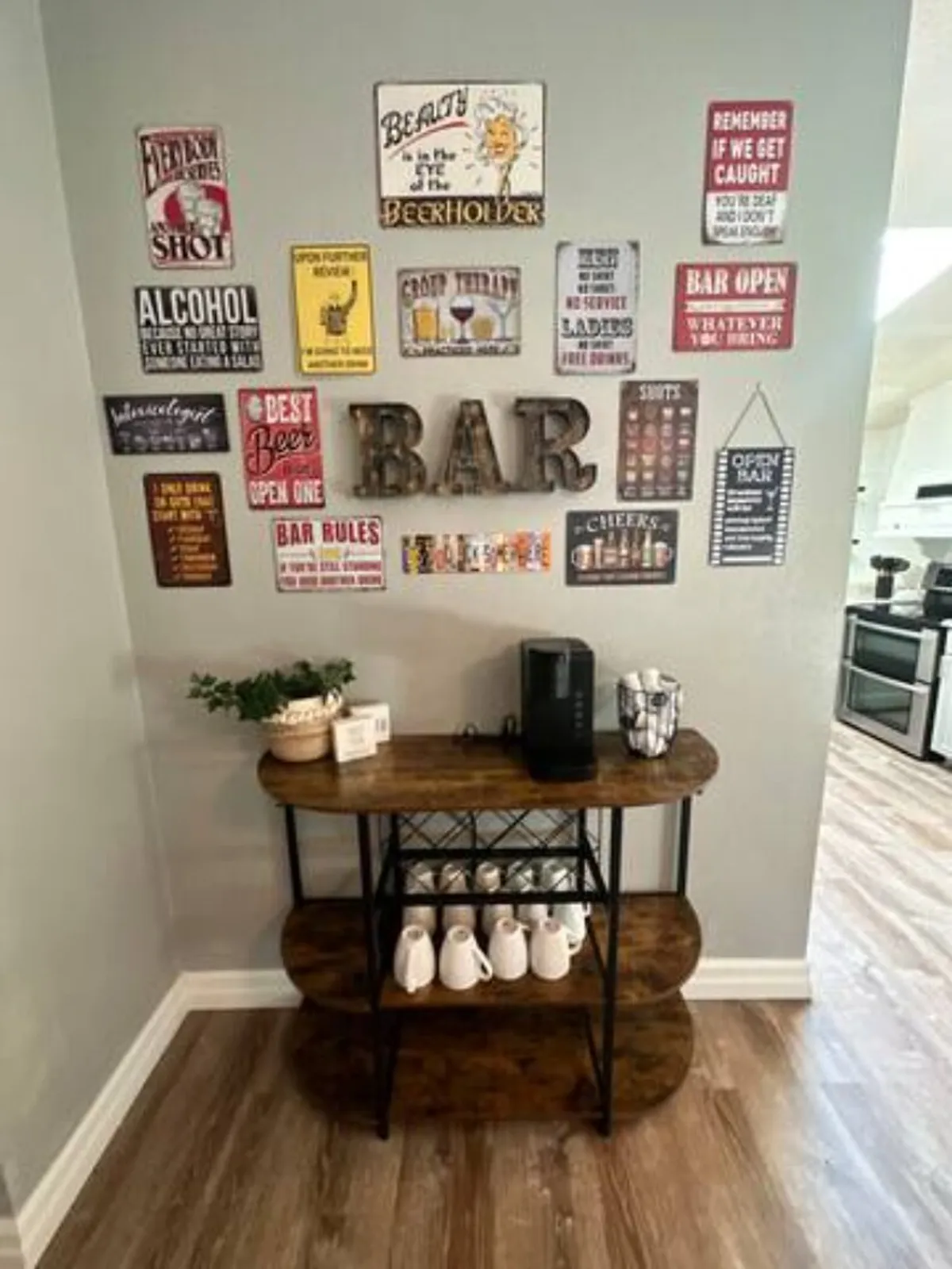 A cozy corner featuring a wooden bar cart adorned with vintage signage, a coffee maker, and a selection of decorative mugs. The scene radiates warmth and charm, inviting guests to share intimate moments over drinks or morning coffee.